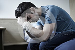 Depressed Young Man With Bandaged Wrists After Suicide Attempt