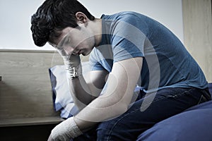 Depressed Young Man With Bandaged Wrists After Suicide Attempt