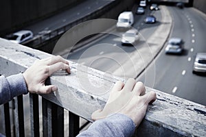 Depressed Young Man Contemplating Suicide On Road Bridge photo