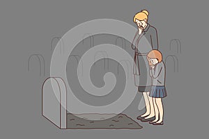 Depressed woman and child crying at tombstone