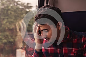 Sad upset man traveling by train.