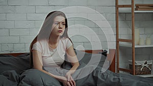Depressed Young Woman Having Depression Sitting In Bed At Home