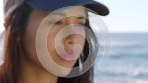 Depressed young woman looking lonely while standing outside at the beach. Female thinking and worrying, suffering from