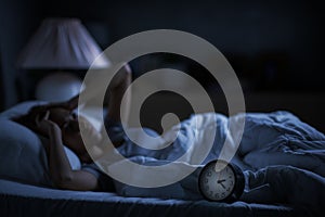 Depressed young woman lying in bed cannot sleep from insomnia