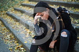 Depressed young woman outdoors