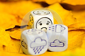 Depressing and sad weather of autumn shown on dice