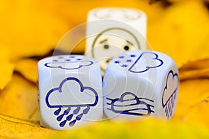 Depressing and sad weather of autumn shown on dice