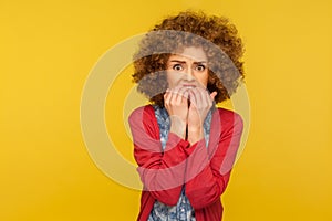 Depression, anxiety disorder. Portrait of stressed out, worried woman with curly hair biting nails and looking terrified