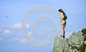 Depression concept. Brave woman stand alone in high mountains blue sky background. Soldier girl. Military female