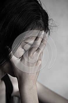 Depression or domestic violence Concept, Desaturated grunge image of a very sad adult woman crying photo