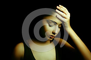 Depression. Sad Young Woman with Face in the Dark