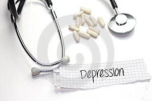 depression text on paper and stethoscope and white medicament.