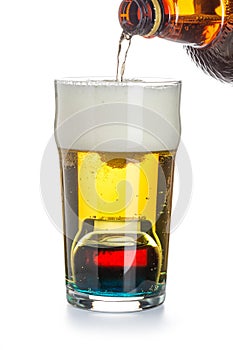 Depth charge cocktail of beer, blue Curacao liqueur, grenadine and vodka, prepared by mixing a submerged inverted Cup at