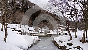 In the depths of winter, the once-flowing stream in Shirakawa village stands still, encased in a layer of ice