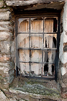 Broken window of derelect cottage in the Scottish village of Kenmore.