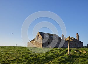 Ruined and abandoned Farm buildings near to the Scottish Coast at Usan, with its roof collapsed in. photo