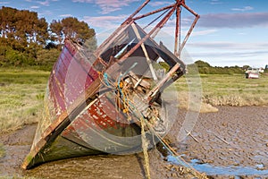 Derelict boat wrecks in mud flats at Heswall