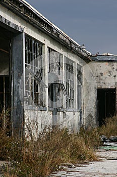 Derelict Building Against Darkening Sky