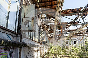 Derelict building with a number of broken and cracked windows and chipped, peeling paint