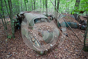 Derelict car covered in debris