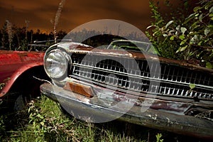 Derelict car at night