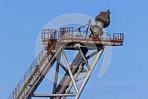 Derelict gas flame tower on an oil rig