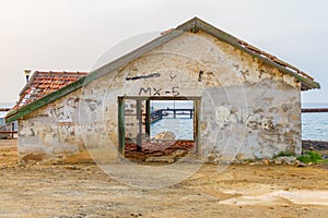 Derelict house by a Pier in Argaka beach, Cyprus. photo