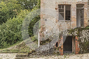 Derelict house with stone; steps leading upwards