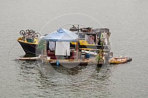 Derelict houseboat afloat