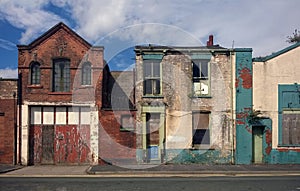 Derelict houses and abandoned garage on a residential street