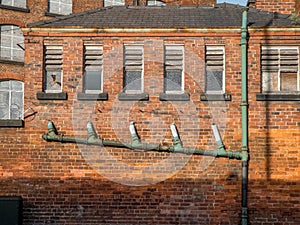 Derelict industrial buildings, with close-up on old plumbing pip