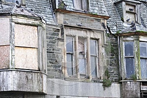 Derelict old victorian hotel building in Dunoon with boards on windows