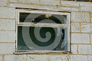 Derelict white building with rotten window