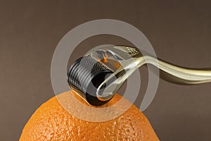 Derma roller for medical micro needling therapy with orange photo