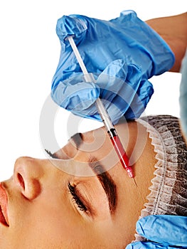 Dermal fillers of woman in spa salon with beautician.