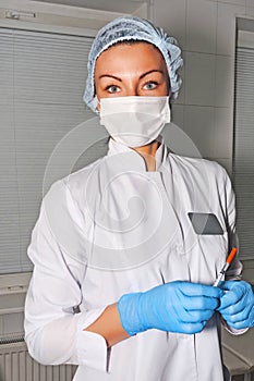 Dermatologist cosmetologist waits her patient with surgical mask
