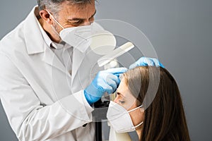 Dermatologist Doctor Checking Woman Hair For Dandruff