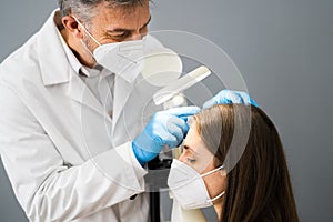 Dermatologist Doctor Checking Woman Hair For Dandruff photo