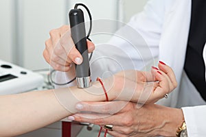 Dermatologist examining birthmarks and moles on a female patient