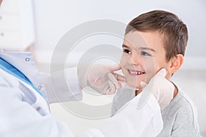 Dermatologist examining little boy`s birthmark