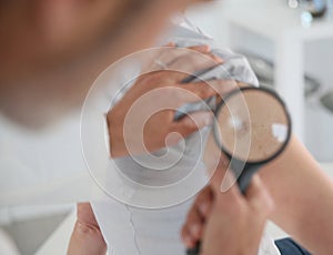 Dermatologist examining mole