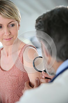 Dermatologist examining mole