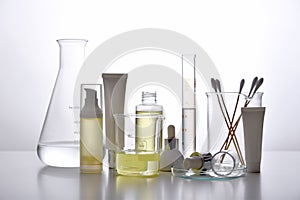 Dermatologist formulating and mixing pharmaceutical skincare, Cosmetic bottle containers and scientific glassware.