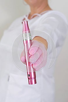 Dermatologist Holding a Pink Dermapen photo