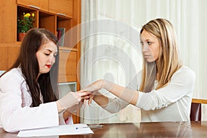 Dermatologist looking at patient hands