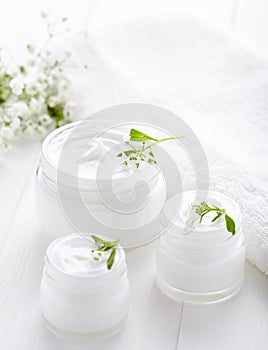 Dermatology herbal cosmetic cream with flowers hygienic skincare product photo