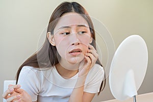 Dermatology, scratch asian young woman looking at mirror, expression worry and itch, itchy allergy or allergic sensitive reaction