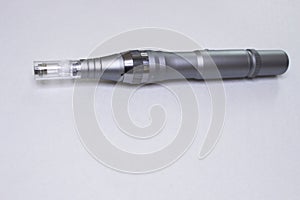 Dermis stamp electric pen. Dermapen. Needle mesotherapy treatment.