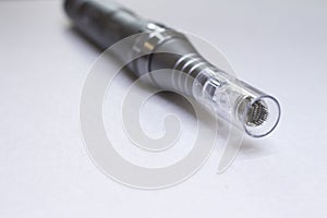 Dermis stamp electric pen. Dermapen. Needle mesotherapy treatment.