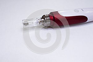 Dermis stamp electric pen. Dermapen. Needle mesotherapy treatment. photo